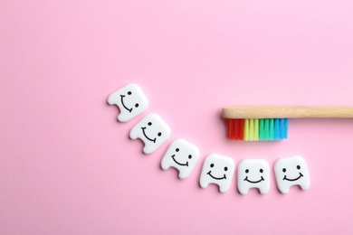 Photo of Flat lay composition with small plastic teeth and wooden brush on color background