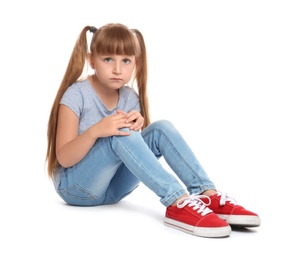 Photo of Full length portrait of little girl with knee problems sitting on white background