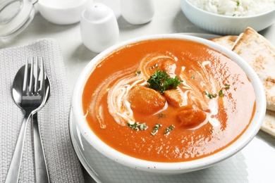 Photo of Delicious butter chicken served on table. Traditional Murgh Makhani dish