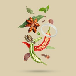 Image of Different spices falling on dark beige background