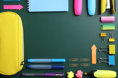 Photo of Flat lay composition with different school stationery on chalkboard surface