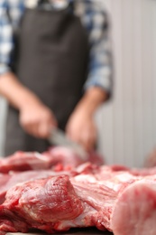Photo of Pieces of fresh raw meat on counter in butcher shop