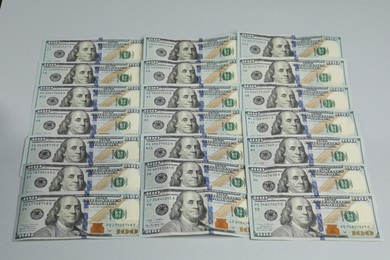 Photo of Money exchange. Dollar banknotes on gray background