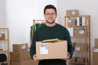 Photo of Seller with parcels in office. Online store