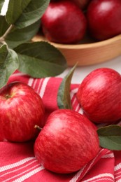 Photo of Fresh red apples with leaves on table