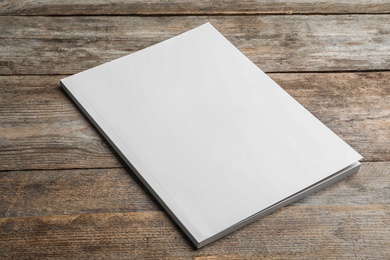 Photo of Brochure with blank cover on wooden background. Mock up for design
