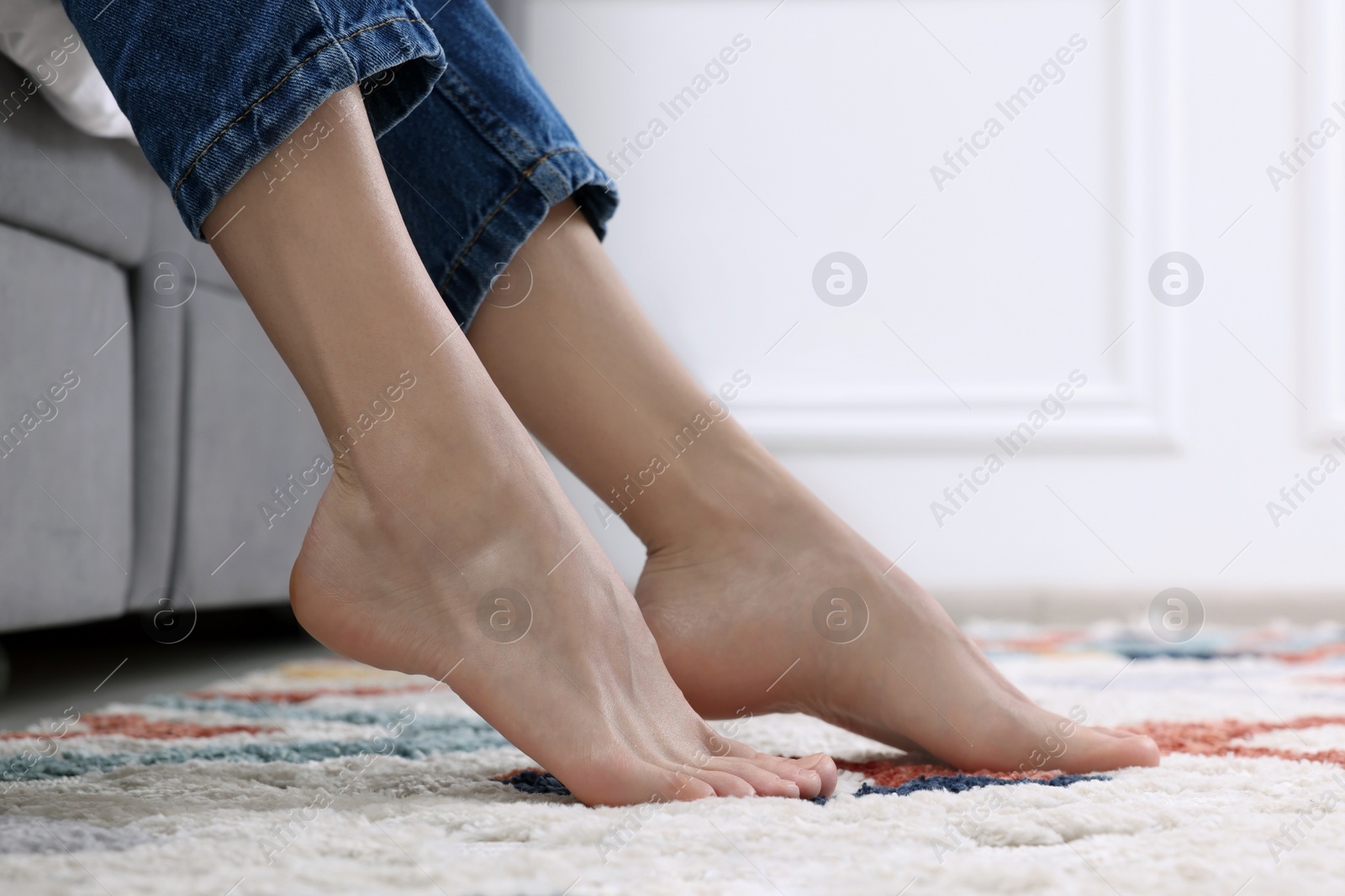 Photo of Woman on carpet with pattern at home, closeup. Space for text