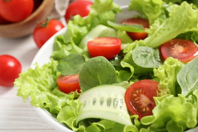 Photo of Delicious vegetable salad on white table, closeup