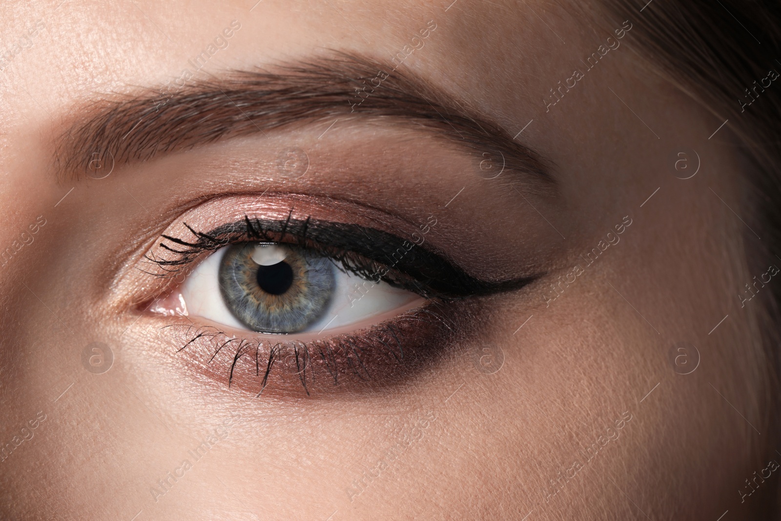 Photo of Beautiful woman with black eyeliner, closeup view