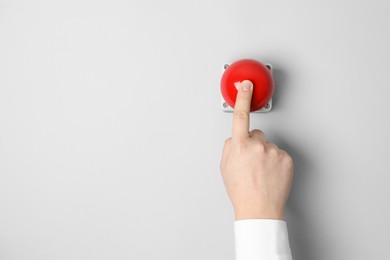 Photo of Man pressing red button of nuclear weapon on white background, top view with space for text. War concept
