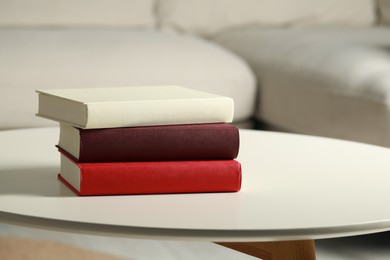Photo of Many different books stacked on white table indoors, space for text