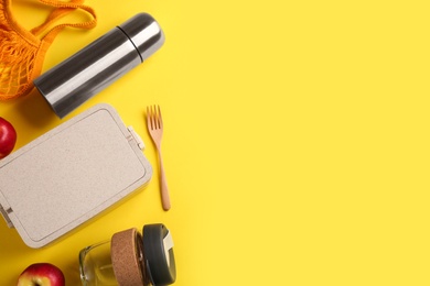 Flat lay composition with thermos on yellow background. Space for text