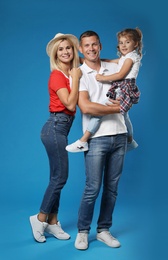 Photo of Happy family with child on blue background