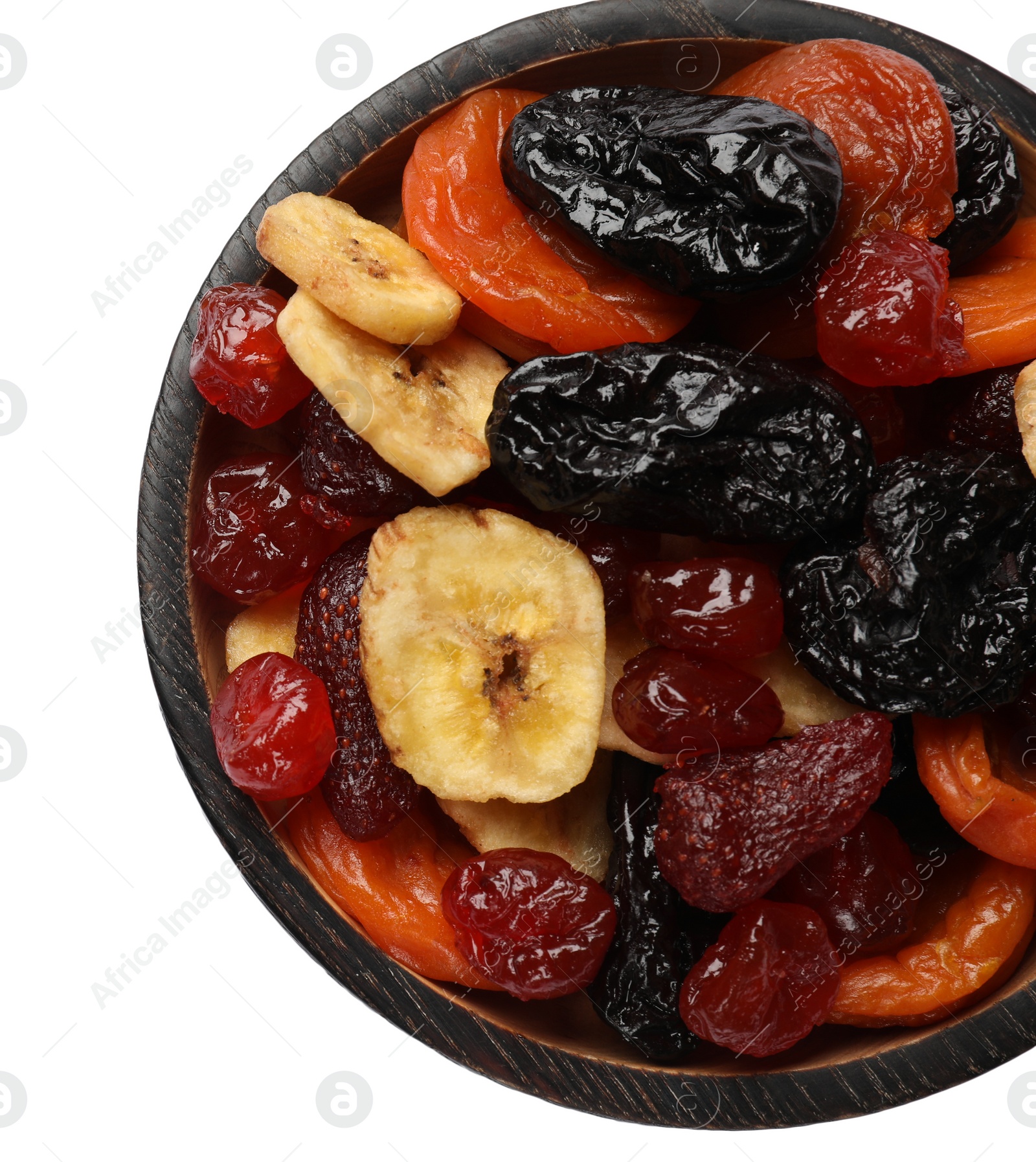 Photo of Mix of delicious dried fruits in wooden bowl isolated on white, top view