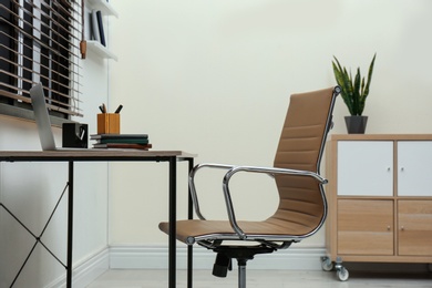 Stylish workplace interior with modern office chair