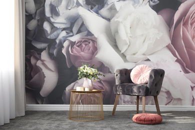 Photo of Comfortable armchair near wall with floral print. Stylish room interior