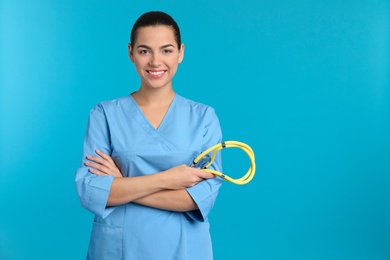 Photo of Portrait of young medical assistant with stethoscope on color background. Space for text