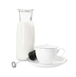 Photo of Milk frother wand, cup and glass carafe isolated on white