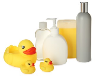 Photo of Bottles of baby cosmetic products and rubber ducks on white background