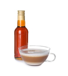 Photo of Bottle of delicious syrup and glass of coffee isolated on white