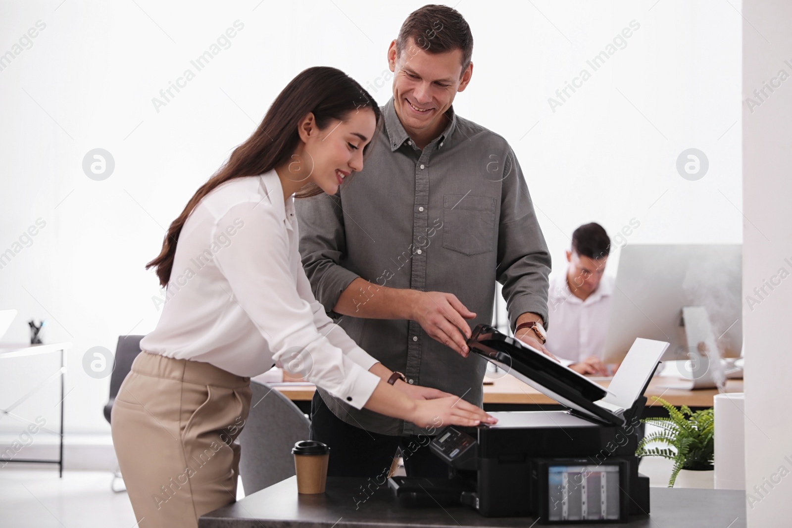 Photo of Employees using new modern printer in office