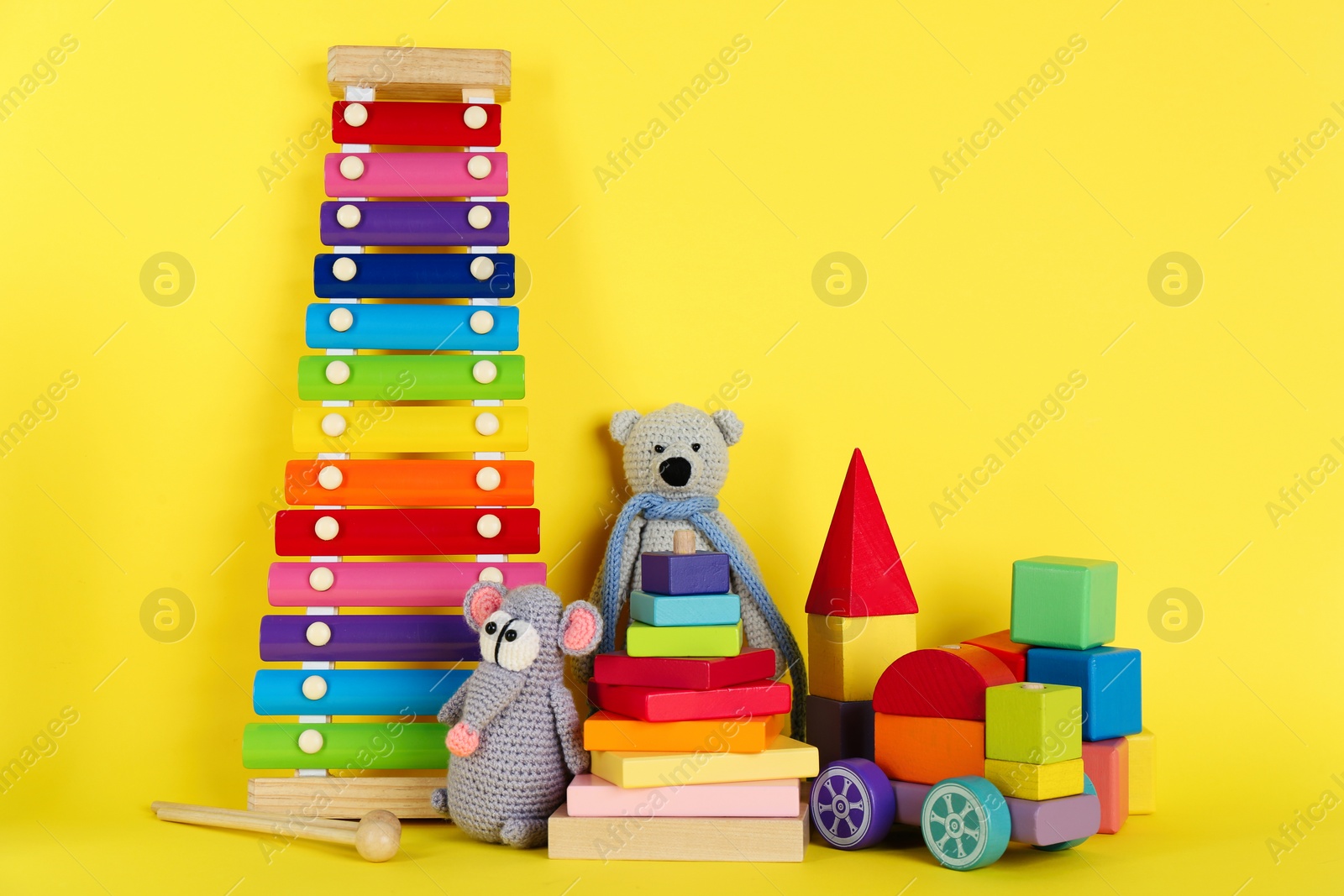 Photo of Set of different toys on yellow background