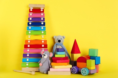 Photo of Set of different toys on yellow background