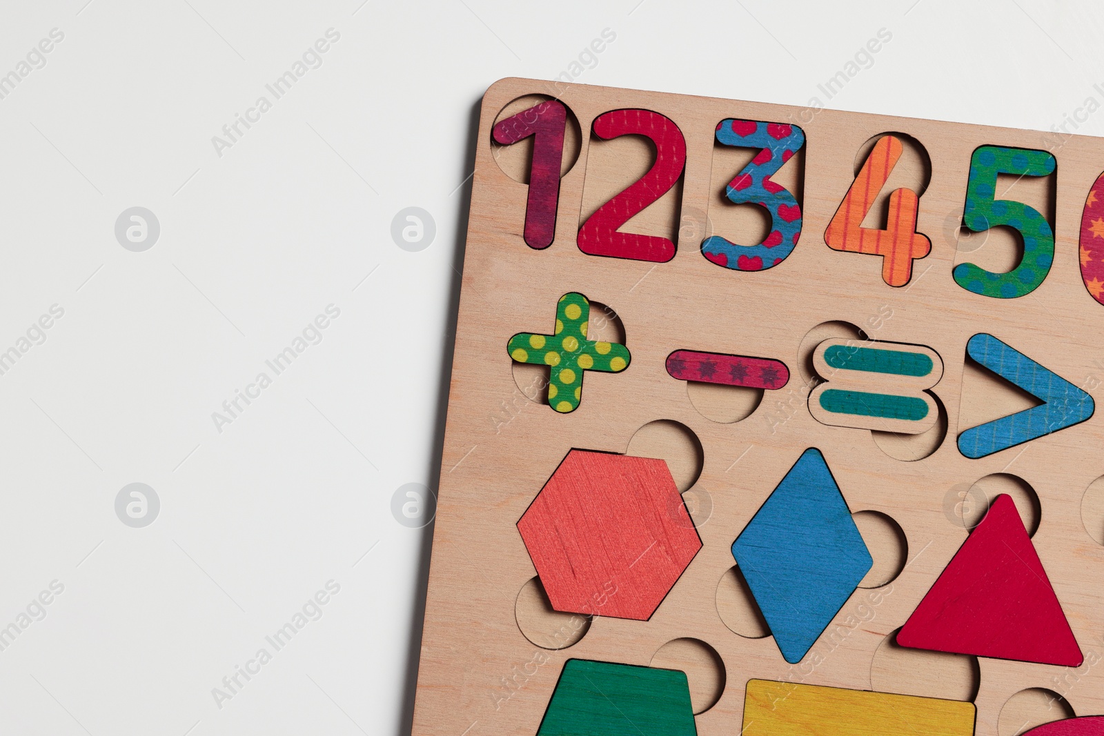 Photo of Wooden math game kit for children on white table, top view. Space for text