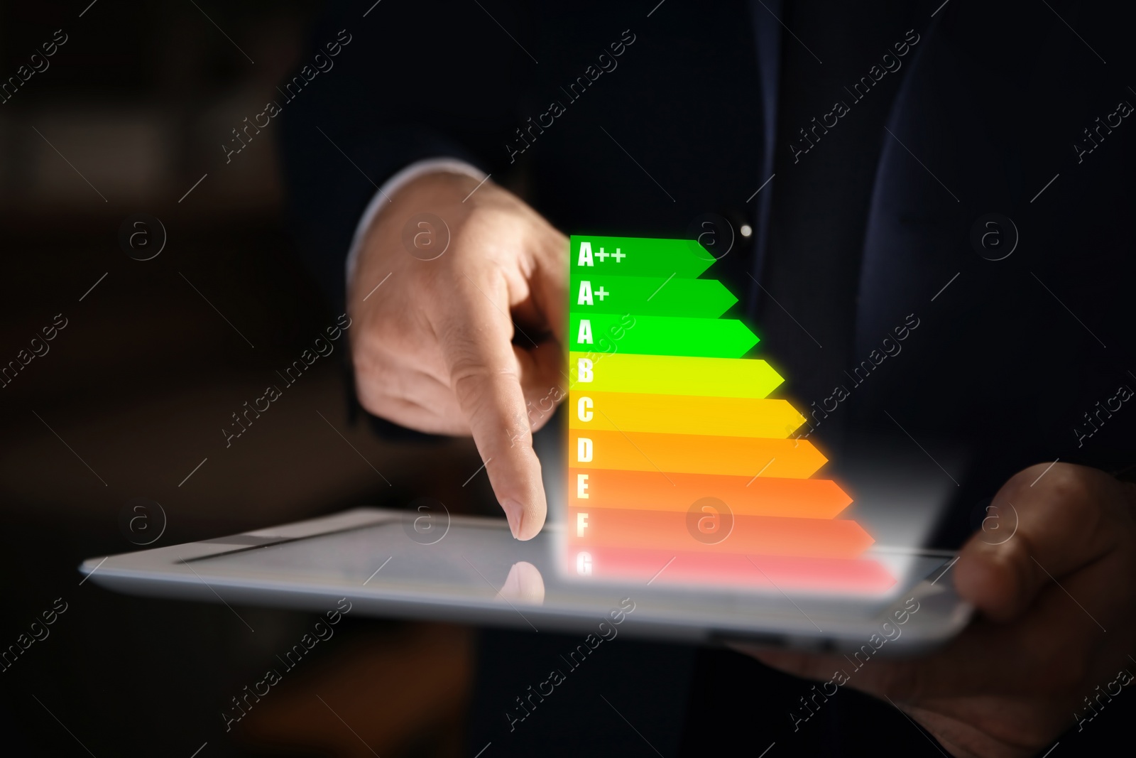 Image of Energy efficiency rating coming out of tablet. Man using device, closeup