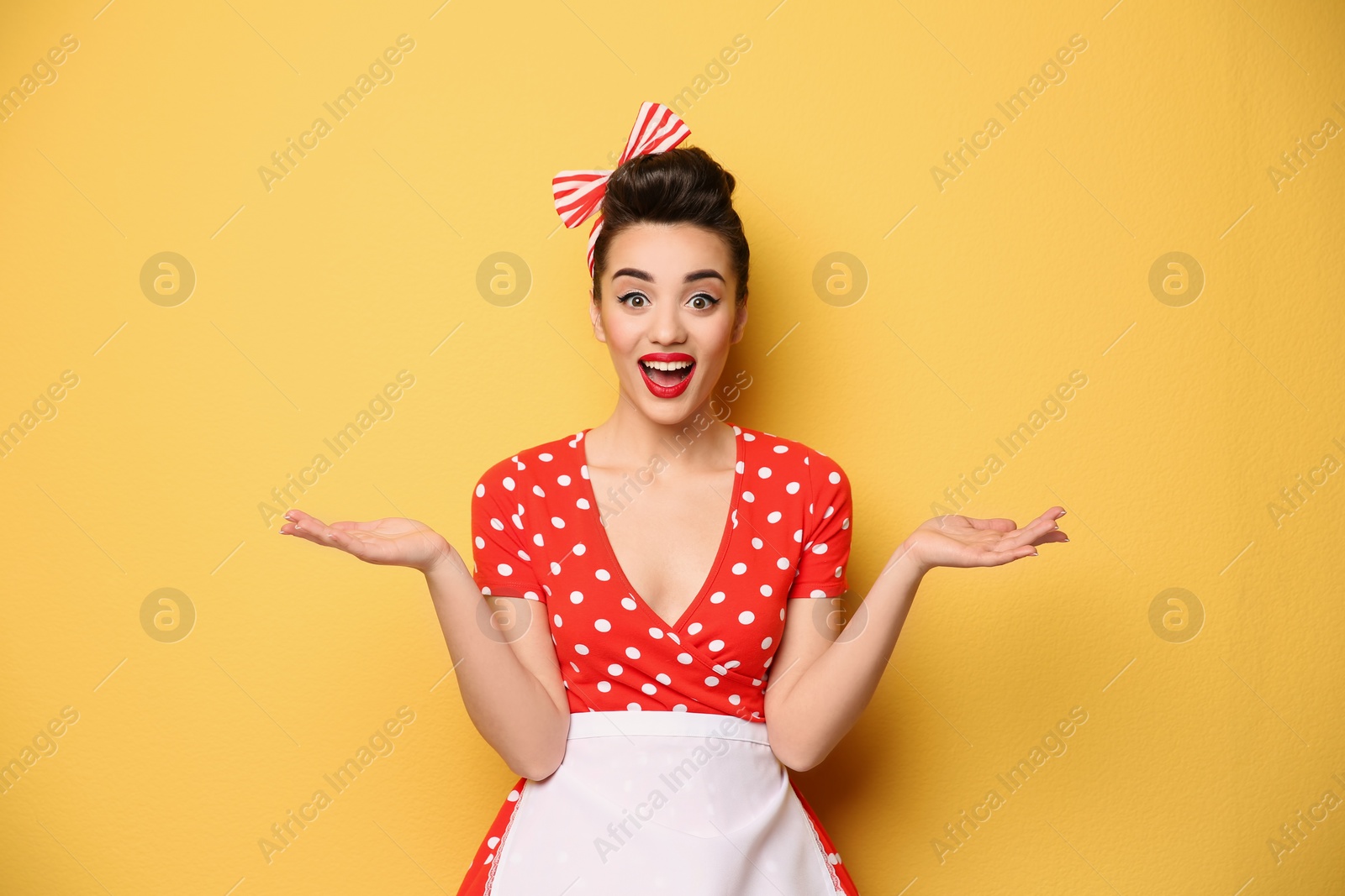 Photo of Portrait of funny young housewife on color background