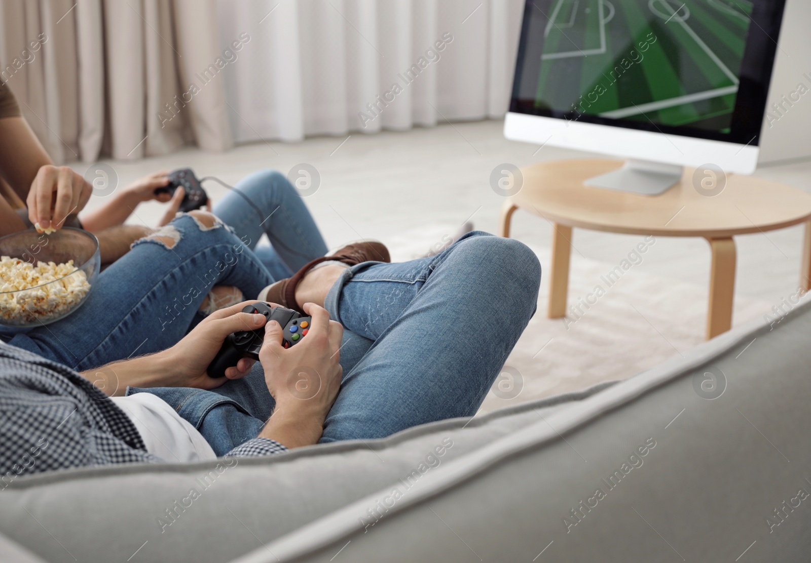 Photo of Group of friends playing video games at home