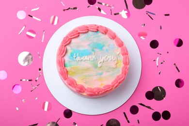 Photo of Cute bento cake with tasty cream and confetti on pink background, flat lay