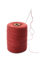 Red sewing thread with needle on white background