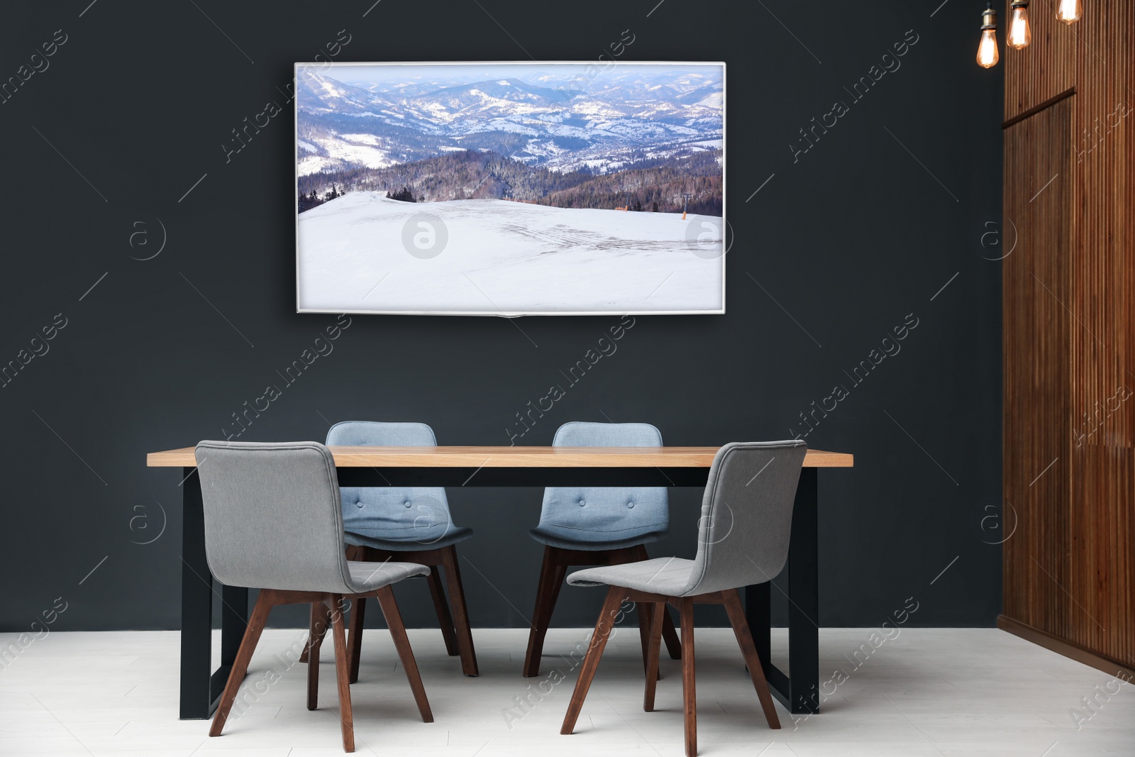 Image of Modern wide screen TV on black wall in room with stylish furniture 