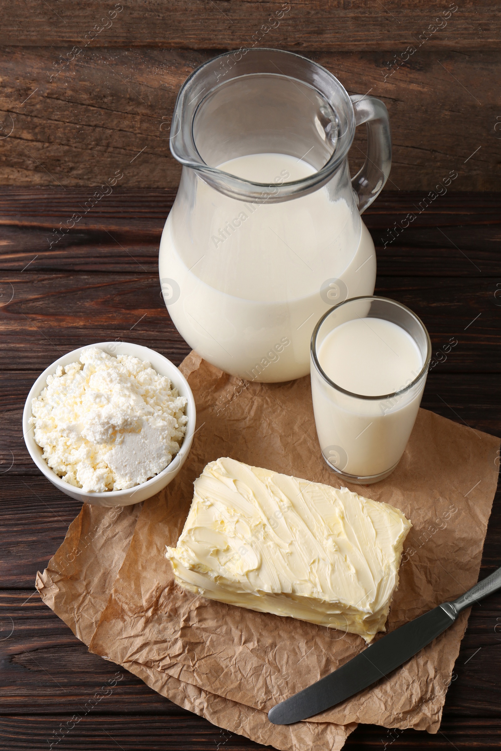 Photo of Tasty homemade butter and dairy products on wooden table