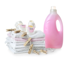 Photo of Fresh baby laundry and bottle of detergent on white background