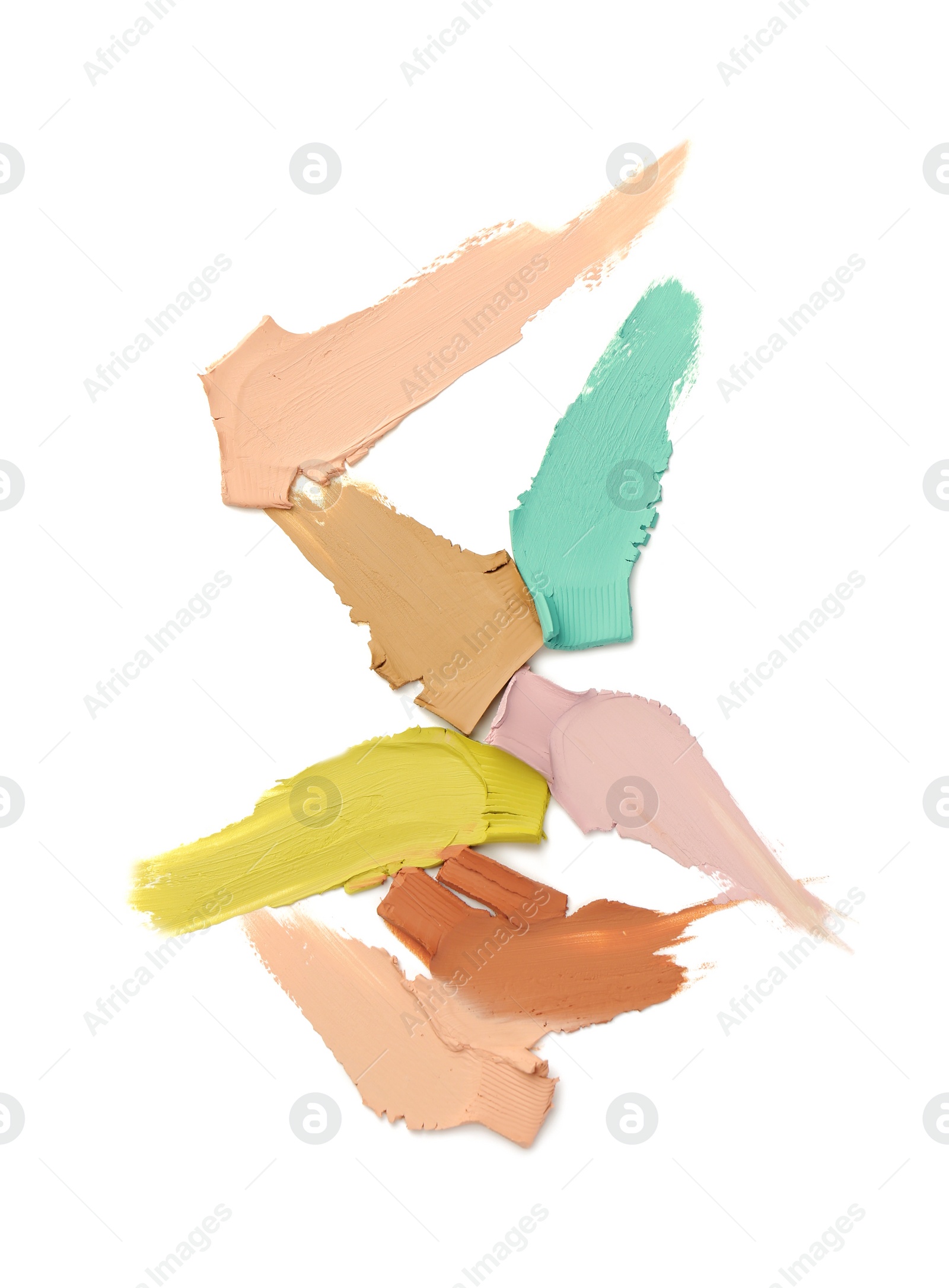 Photo of Samples of color correcting concealers isolated on white, top view