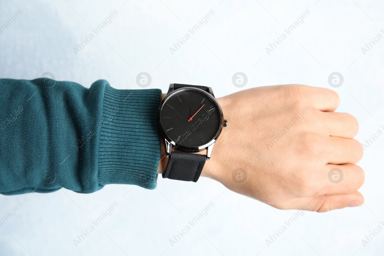 Photo of Man with stylish wrist watch on color background, closeup. Time management