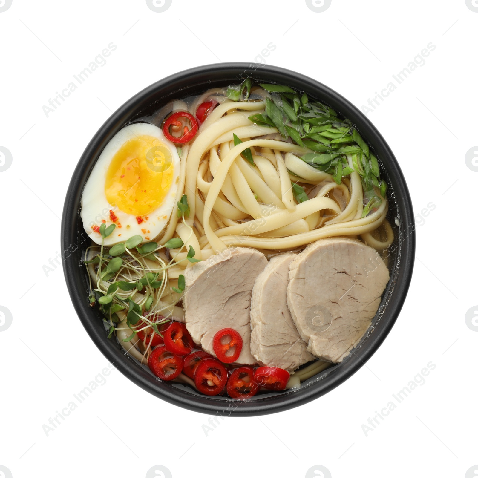 Photo of Delicious ramen with meat and egg in bowl isolated on white, top view. Noodle soup