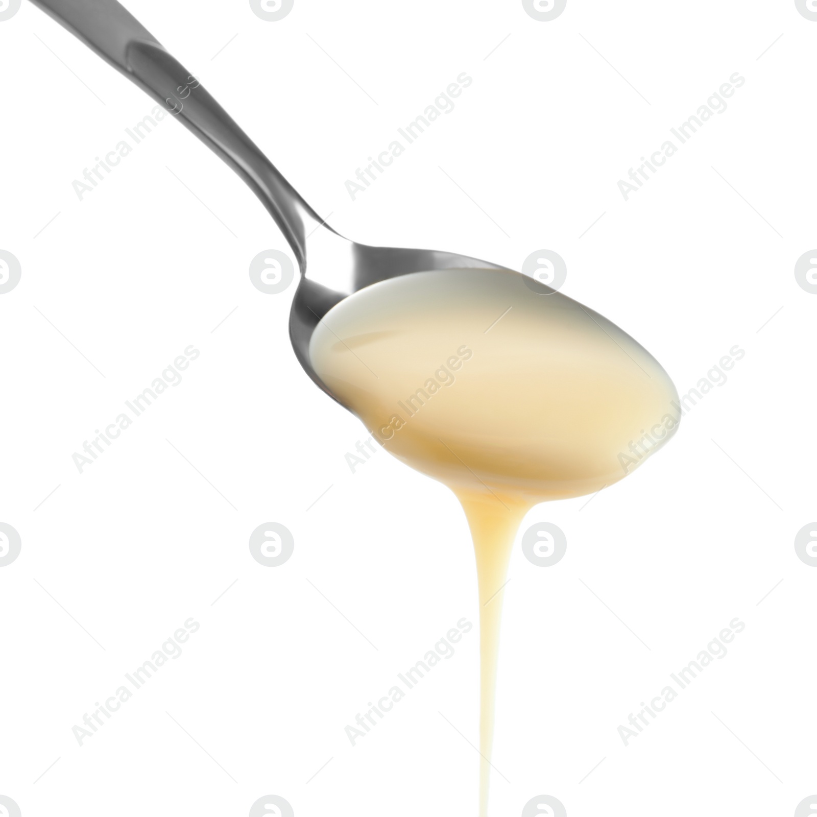 Photo of Spoon with condensed milk on white background, closeup. Dairy product