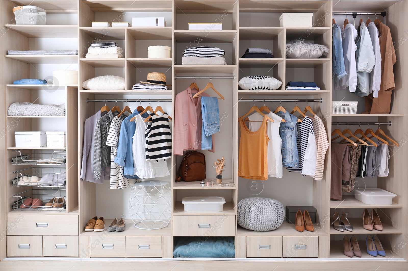 Photo of Stylish clothes, shoes and home stuff in large wardrobe closet