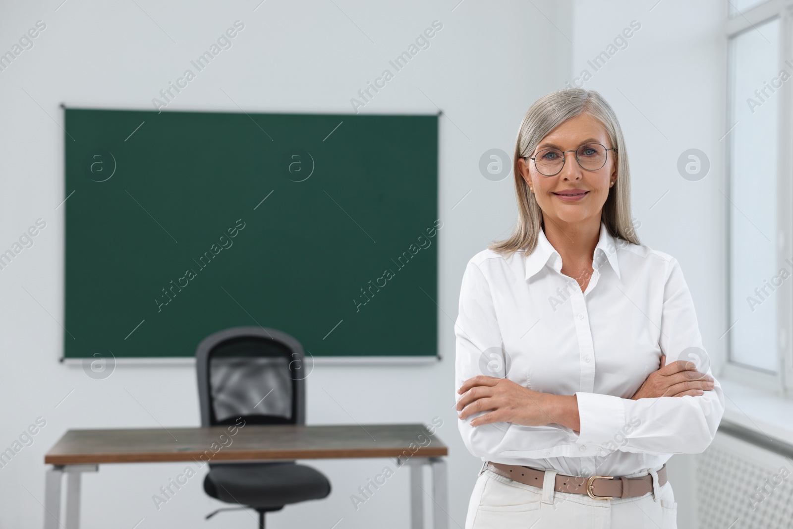 Photo of Portrait of smiling professor in classroom, space for text