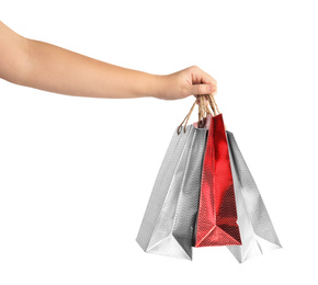 Photo of Woman holding paper shopping bags on white background, closeup