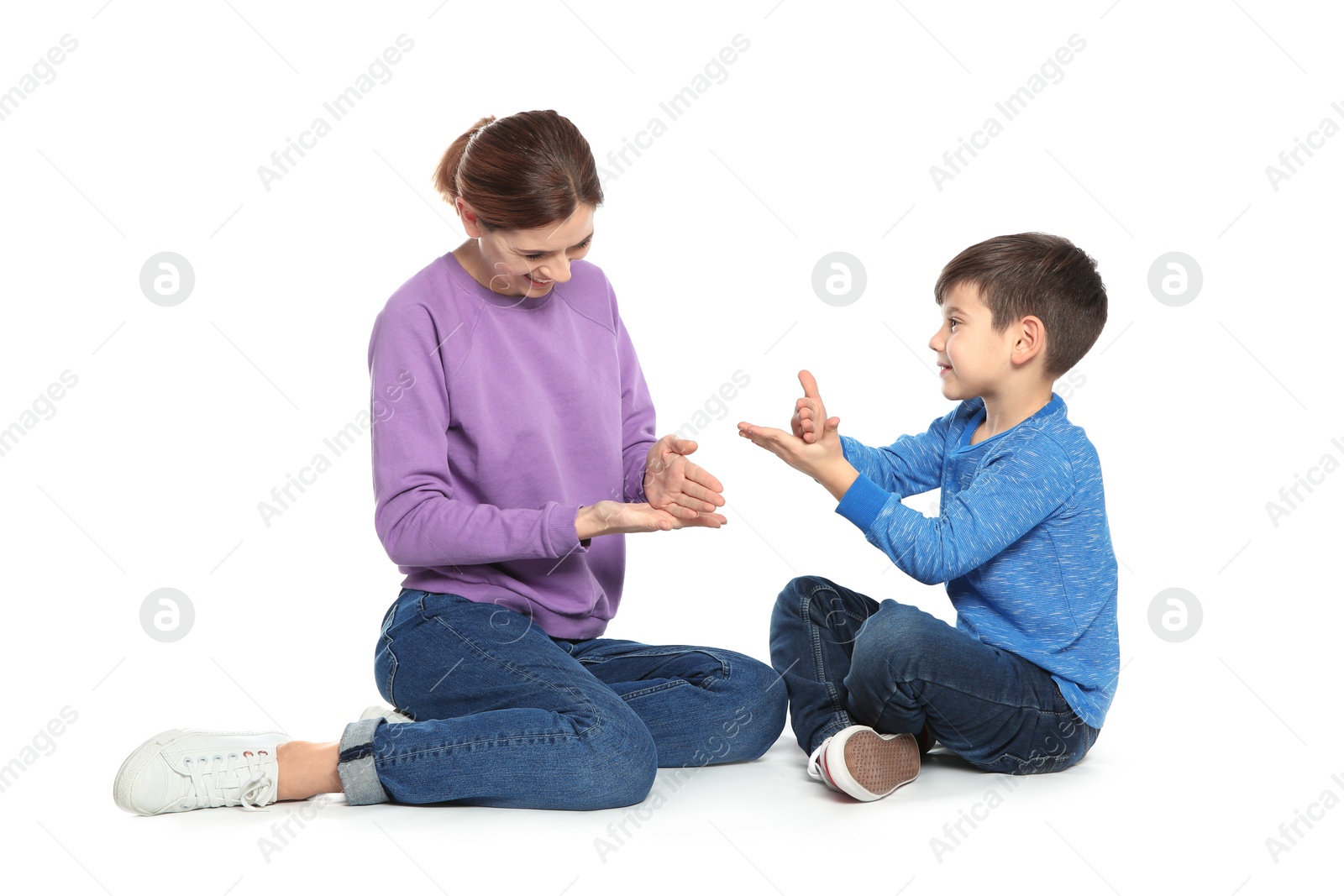 Photo of Hearing impaired mother and her child talking with help of sign language on white background