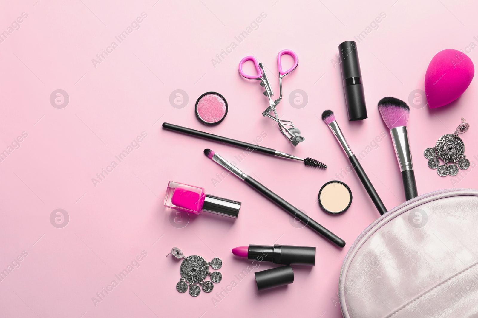 Photo of Makeup products with cosmetic bag on color background