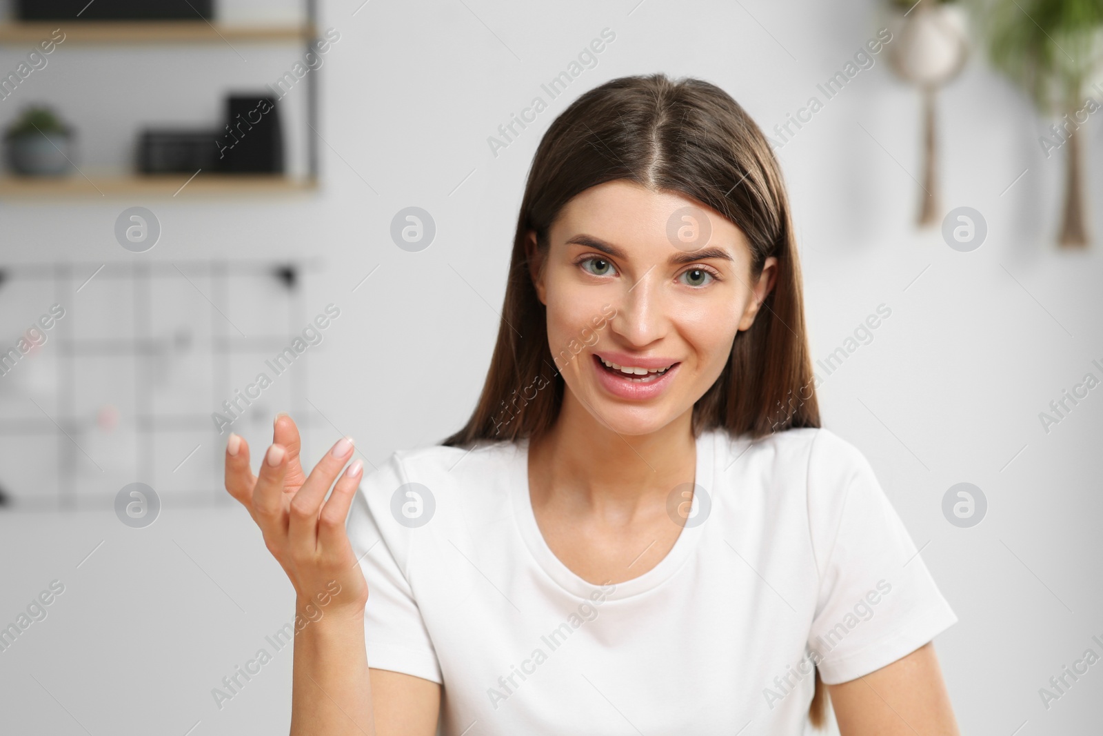 Photo of Happy woman having online video call at home, view from web camera