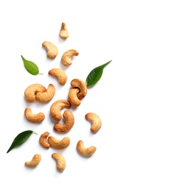 Photo of Tasty cashew nuts and leaves isolated on white, top view. Space for text