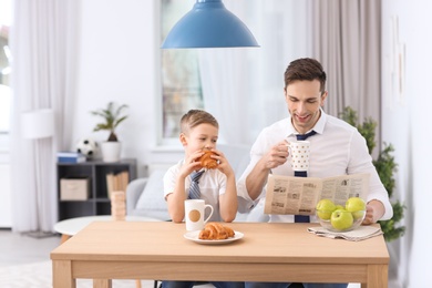 Dad and his son having breakfast at home