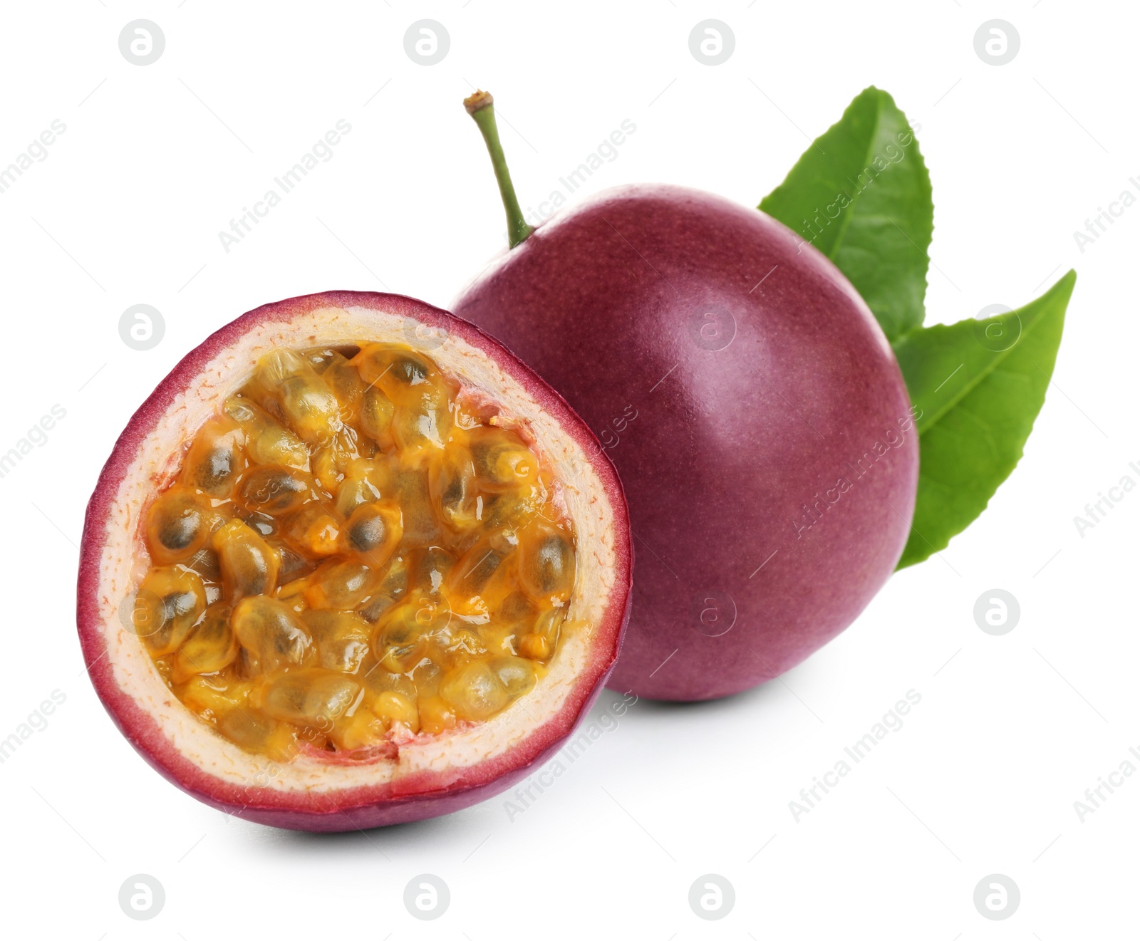 Photo of Fresh ripe passion fruits (maracuyas) with green leaves isolated on white