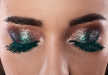 Young woman with color eyelashes and beautiful makeup, closeup